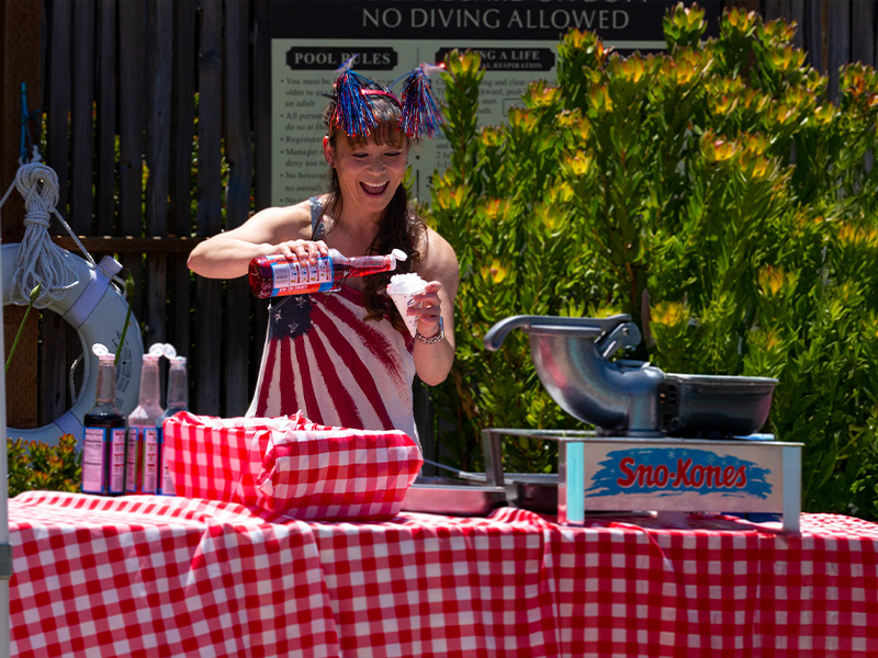 Kimi, fitness instructor and manager, making a so-cone at a holiday event.