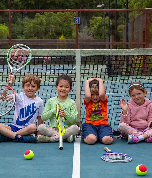 Child smiling during tennis camp