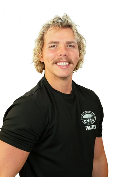 Logan, Personal Trainer, smiling with a white background.