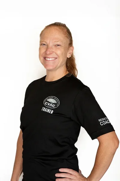 Megan, Personal Trainer, smiles on a white background