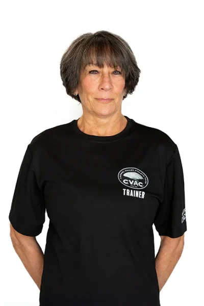 Terri, Personal Trainer, smiles on a white background